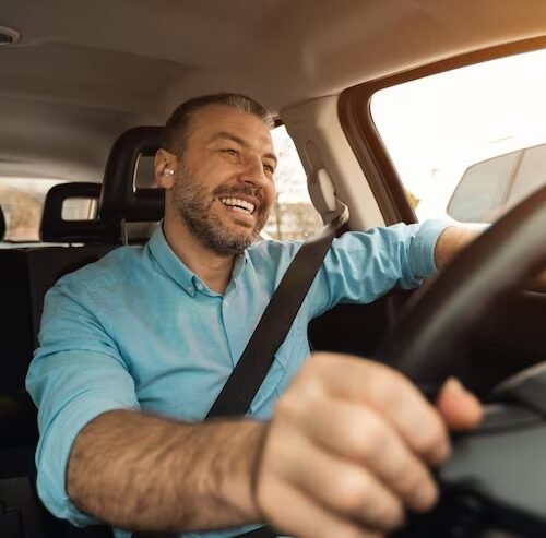 happy-man-earphones-enjoying-music-driving-luxury-car_116547-24207